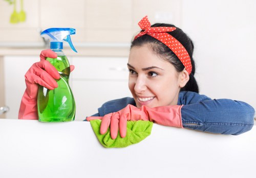 Staff member wearing PPE while cleaning carpets safely