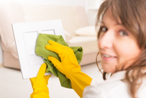 Office cleaning team sanitising desks and communal areas in SW17